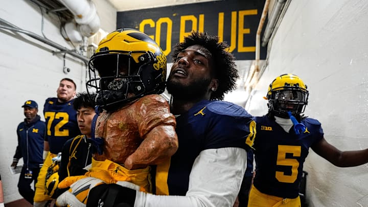 Michigan defensive end Josaiah Stewart (0) holds the Paul Bunyan Trophy back into the tunnel after 24-17 win over Michigan State at Michigan Stadium in Ann Arbor on Saturday, Oct. 26, 2024. Michigan defensive end Josaiah Stewart (0) holds the Paul Bunyan Trophy back into the tunnel after 24-17 win over Michigan State at Michigan Stadium in Ann Arbor on Saturday, Oct. 26, 2024.