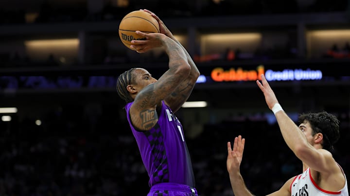 Oct 28, 2024; Sacramento, California, USA; Sacramento Kings forward DeMar DeRozan (10) shoots the ball against Portland Trail Blazers forward Deni Avdija (8) during the third quarter at Golden 1 Center. Mandatory Credit: Sergio Estrada-Imagn Images