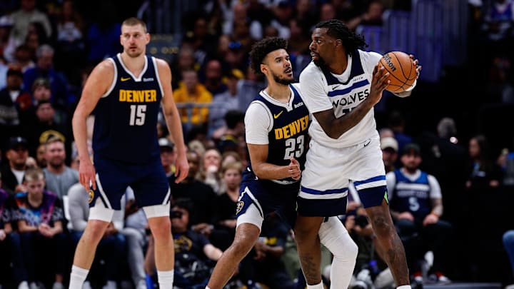Apr 27, 2026; Denver, Colorado, USA; Minnesota Timberwolves center Naz Reid (11) controls the ball under pressure from Denver Nuggets forward Cameron Johnson (23) as center Nikola Jokic (15) defends in the fourth quarter during game five of the first round of the 2026 NBA Playoffs at Ball Arena. Mandatory Credit: Isaiah J. Downing-Imagn Images