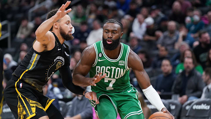 Jan 19, 2023; Boston, Massachusetts, USA; Boston Celtics guard Jaylen Brown (7) drives the ball against Golden State Warriors guard Stephen Curry (30) in the second half at TD Garden. Mandatory Credit: David Butler II-Imagn Images