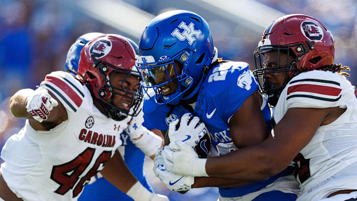Sep 7, 2024; Lexington, Kentucky, USA; Kentucky Wildcats running back Jason Patterson (26) runs the ball through South Carolina Gamecocks defenders during the second quarter at Kroger Field. Mandatory Credit: Jordan Prather-Imagn Images