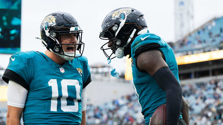 Dec 29, 2024; Jacksonville, Florida, USA; Jacksonville Jaguars wide receiver Brian Thomas Jr (7) and quarterback Mac Jones (10) celebrate a touchdown against the Tennessee Titans in the fourth quarter at EverBank Stadium. 