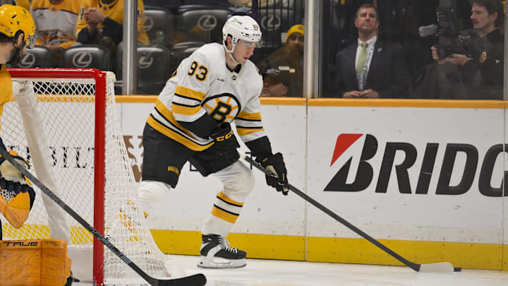 Mar 5, 2026; Nashville, Tennessee, USA;  during the second period at Bridgestone Arena. Mandatory Credit: Steve Roberts-Imagn ImagesBoston Bruins center Fraser Minten (93) skates behind the net against the Nashville Predators 