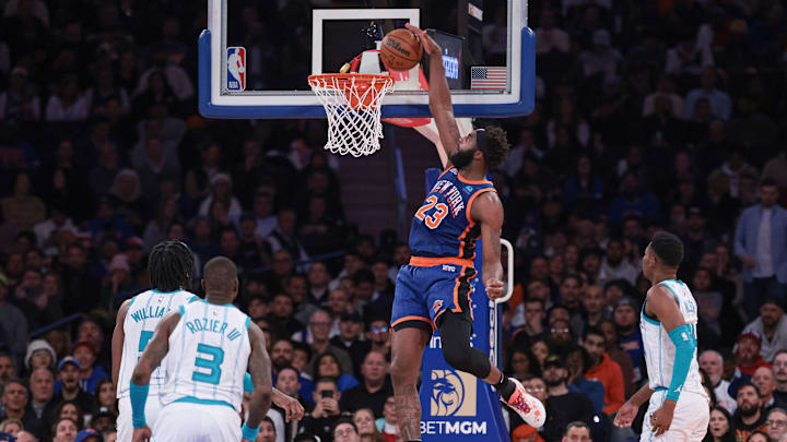 Nov 28, 2023; New York, New York, USA; New York Knicks center Mitchell Robinson (23) dunks in front of Charlotte Hornets center Mark Williams (5) and guard Terry Rozier (3) and forward Brandon Miller (24) during the second half at Madison Square Garden. Mandatory Credit: Vincent Carchietta-Imagn Images