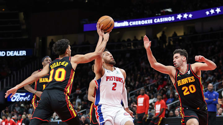Feb 23, 2025; Atlanta, Georgia, USA; Atlanta Hawks forward Zaccharie Risacher (10) and forward Georges Niang (20) cause turnover against Detroit Pistons guard Cade Cunningham (2) during the first quarter at State Farm Arena. Mandatory Credit: Jordan Godfree-Imagn Images