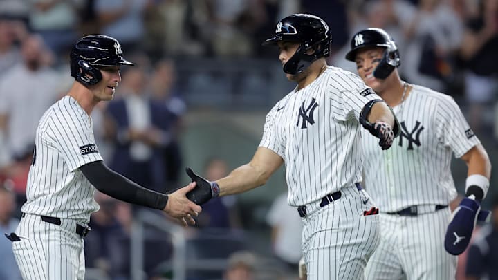 Jul 8, 2025; Bronx, New York, USA; New York Yankees designated hitter Giancarlo Stanton (27) celebrates his three run home run against the Seattle Mariners with center fielder Cody Bellinger (35) and right fielder Aaron Judge (99) during the sixth inning at Yankee Stadium. Mandatory Credit: Brad Penner-Imagn Images