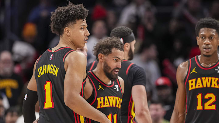 Dec 28, 2024; Atlanta, Georgia, USA; Atlanta Hawks guard Trae Young (11) reacts with forward Jalen Johnson (1) after the Hawks defeated the Miami Heat at State Farm Arena. Mandatory Credit: Dale Zanine-Imagn Images
