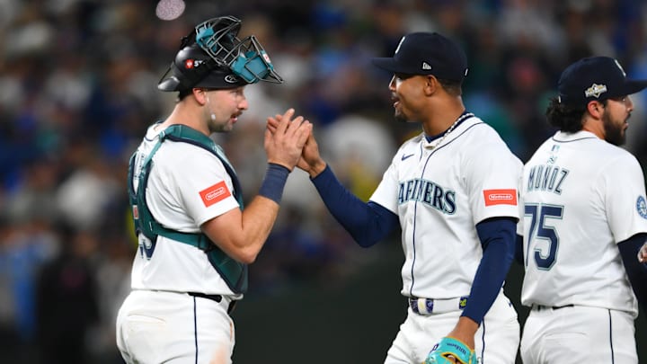 Oct 5, 2025; Seattle, Washington, USA; Seattle Mariners center fielder Julio Rodriguez (44) and catcher Cal Raleigh (29) celebrate after defeating the Detroit Tigers in game two of the ALDS round for the 2025 MLB playoffs at T-Mobile Park. Mandatory Credit: Steven Bisig-Imagn Images