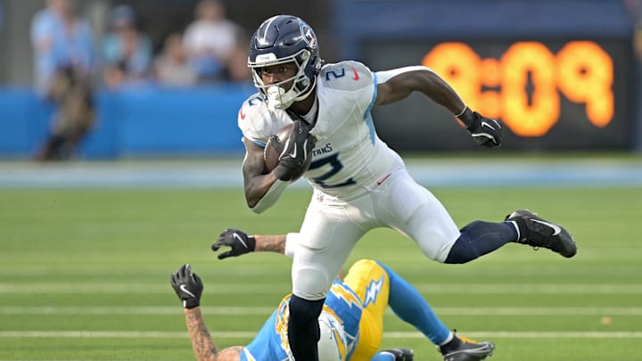 Nov 10, 2024; Inglewood, California, USA;  Tennessee Titans running back Tyjae Spears (2) gets past Los Angeles Chargers cornerback Elijah Molden (22) for a first down in the first half at SoFi Stadium. Mandatory Credit: Jayne Kamin-Oncea-Imagn Images