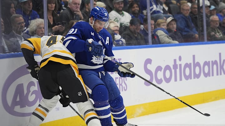 Nov 3, 2025; Toronto, Ontario, CAN; Toronto Maple Leafs forward John Tavares (91) battles with Pittsburgh Penguins defenseman Harrison Brunicke (45) during the first period at Scotiabank Arena. Mandatory Credit: John E. Sokolowski-Imagn Images