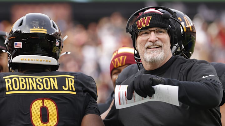 Dec 1, 2024; Landover, Maryland, USA; Washington Commanders head coach Dan Quinn (right) celebrates with Commanders running back Brian Robinson Jr. (8) after scoring a touchdown against the Tennessee Titans during the first half at Northwest Stadium. Mandatory Credit: Amber Searls-Imagn Images