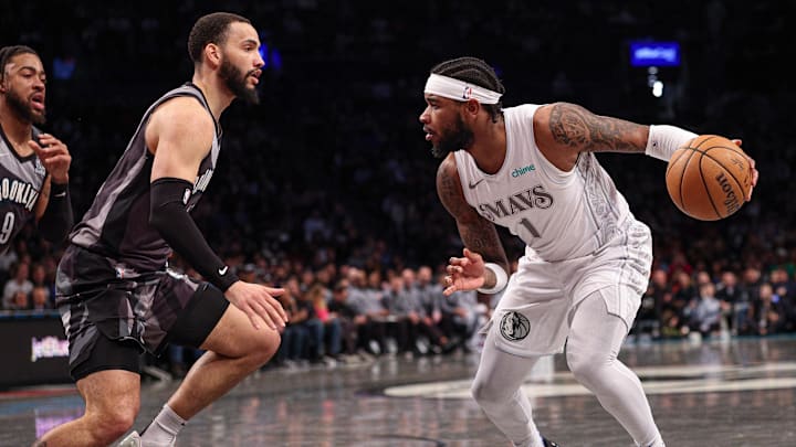 Mar 24, 2025; Brooklyn, New York, USA; Dallas Mavericks guard Jaden Hardy (1) dribbles as Brooklyn Nets guard Tyrese Martin (13) defends during the second half at Barclays Center. Mandatory Credit: Vincent Carchietta-Imagn Images