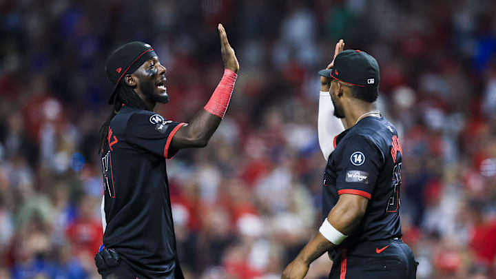 Sep 19, 2025; Cincinnati, Ohio, USA; Cincinnati Reds shortstop Elly De La Cruz (44) high fives designated hitter Miguel Andujar (38) after the victory over the Chicago Cubs at Great American Ball Park. 