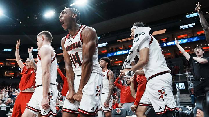 Louisville Cardinals guard Adrian Wooley (14) and the rest of the bench erupts in cheers as teammate Cole Sherman hits a late three-point shot against Eastern Michigan as the Cards roll 87-46 to improve to 6-0 Monday night, Nov. 24, 2025 at the KFC Yum! Center in Louisville, Kentucky.
