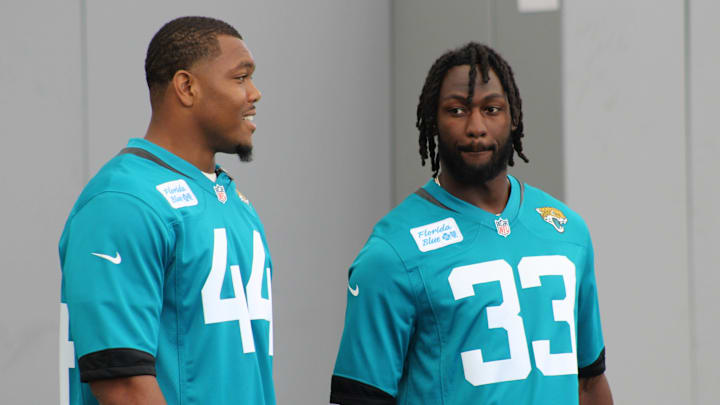 Jaguars linebackers Devin Lloyd and Travon Walker prepare to talk to players during the 2023 Jaguars' QB Skills Challenge at TIAA Bank.