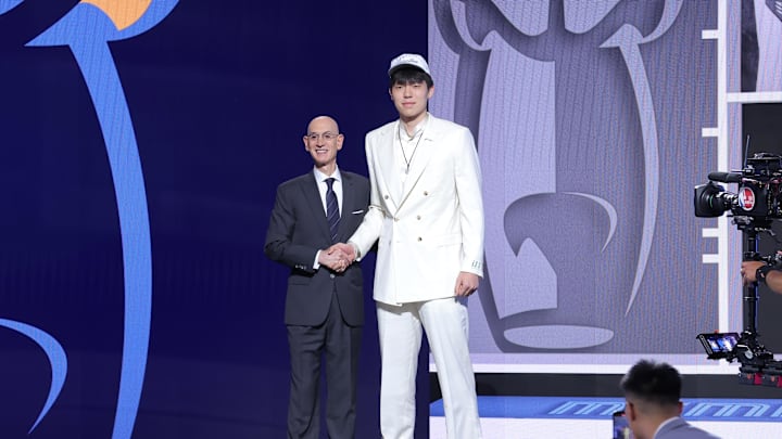 Jun 25, 2025; Brooklyn, NY, USA;  Yang Hansen stands with NBA commissioner Adam Silver after being selected as the 16th pick by the Memphis Grizzlies in the first round of the 2025 NBA Draft at Barclays Center. Mandatory Credit: Brad Penner-Imagn Images
