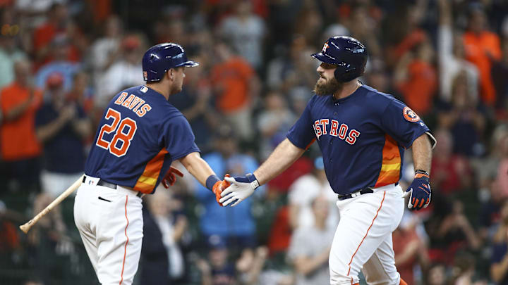 Jul 29, 2018; Houston, TX, USA; Houston Astros first baseman Tyler White (13) celebrates with third baseman J.D. Davis (28) after hitting a home run during the second inning against the Texas Rangers at Minute Maid Park. Mandatory Credit: Troy Taormina-Imagn Images