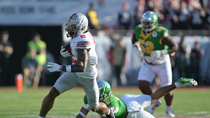 Jan 1, 2025; Pasadena, CA, USA; Ohio State Buckeyes wide receiver Emeka Egbuka (2) runs against Oregon Ducks defensive back Kobe Savage (5) in the first quarter in the 2025 Rose Bowl college football quarterfinal game at Rose Bowl Stadium. Mandatory Credit: Jayne Kamin-Oncea-Imagn Images