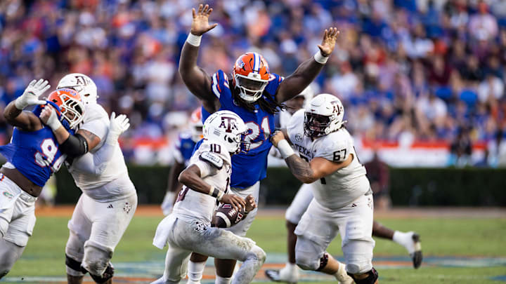 Florida Gators defensive lineman Desmond Watson (21) attempts to tackle Texas A&M Aggies quarterback Marcel Reed (10) during the second half at Ben Hill Griffin Stadium.