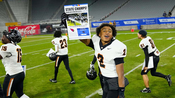 Desert Edge receiver Zerek Sidney (2) celebrates with his teammates after winning the 5A State Championship game in 2024.