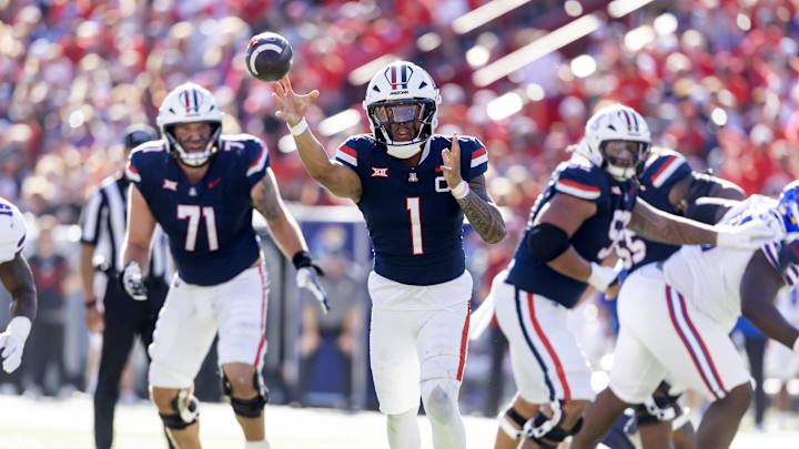 Nov 8, 2025; Tucson, Arizona, USA; Arizona Wildcats quarterback Noah Fifita (1) throws a touchdown pass against the Kansas Jayhawks in the first half at Arizona Stadium. Mandatory Credit: Mark J. Rebilas-Imagn Images Nov 8, 2025; Tucson, Arizona, USA; Arizona Wildcats quarterback Noah Fifita (1) throws a touchdown pass against the Kansas Jayhawks in the first half at Arizona Stadium. Mandatory Credit: Mark J. Rebilas-Imagn Images