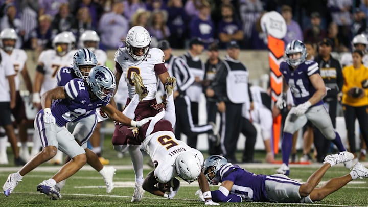 Nov 16, 2024; Manhattan, Kansas, USA; Arizona State Sun Devils wide receiver Melquan Stovall (5) is tackled by Kansas State Wildcats cornerback Jacob Parrish (10) and safety Marques Sigle (21) during the fourth quarter at Bill Snyder Family Football Stadium. Mandatory Credit: Scott Sewell-Imagn Images
