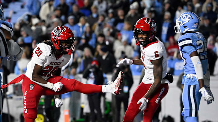Nov 30, 2024; Chapel Hill, North Carolina, USA; North Carolina State Wolfpack running back Hollywood Smothers (20) reacts with wide receiver Wesley Grimes (6) after scoring a touchdown with 25 seconds to go in the fourth quarter at Kenan Memorial Stadium. 