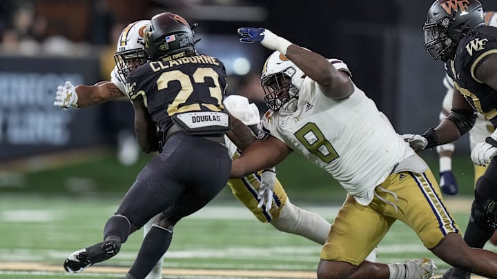 Sep 23, 2023; Winston-Salem, North Carolina, USA; Wake Forest Demon Deacons running back Demond Claiborne (23) is tackled by Georgia Tech Yellow Jackets defensive lineman Makius Scott (8) during the first half at Allegacy Federal Credit Union Stadium. Mandatory Credit: Jim Dedmon-Imagn Images Sep 23, 2023; Winston-Salem, North Carolina, USA; Wake Forest Demon Deacons running back Demond Claiborne (23) is tackled by Georgia Tech Yellow Jackets defensive lineman Makius Scott (8) during the first half at Allegacy Federal Credit Union Stadium. Mandatory Credit: Jim Dedmon-Imagn Images