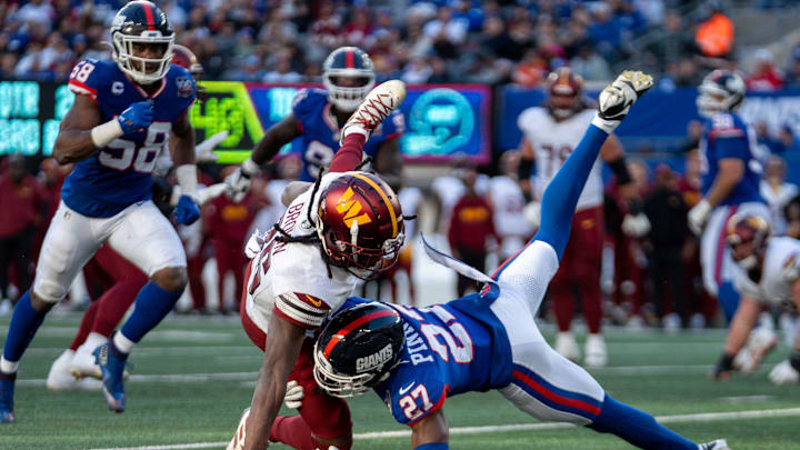 Washington Commanders wide receiver Noah Brown (85) is tackled by New York Giants safety Jason Pinnock (27) after catching a pass during a game between the New York Giants and the Washington Commanders at MetLife Stadium in East Rutherford on Sunday, Nov. 3, 2024.