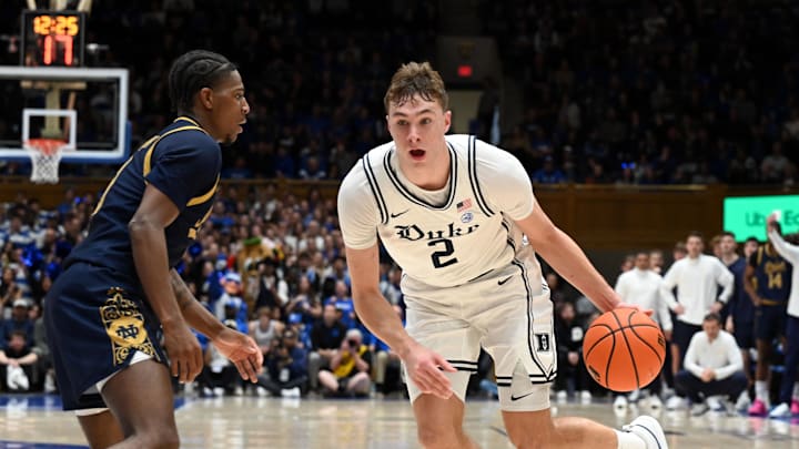 Jan 11, 2025; Durham, North Carolina, USA;  Duke Blue Devils forward Cooper Flagg (2) drives to the basket as Notre Dame Fighting Irish guard Markus Burton (3) defends during the first half at Cameron Indoor Stadium. Mandatory Credit: Rob Kinnan-Imagn Images