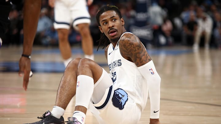 Dec 5, 2024; Memphis, Tennessee, USA; Memphis Grizzlies guard Ja Morant (12) reacts after falling during the first quarter against the Sacramento Kings at FedExForum. Mandatory Credit: Petre Thomas-Imagn Images