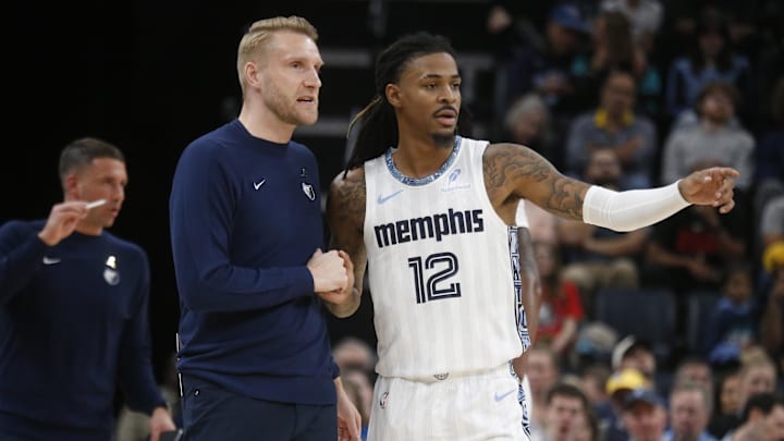 Dec 26, 2025; Memphis, Tennessee, USA; Memphis Grizzlies head coach Tuomas Iisalo talks with guard Ja Morant (12) during the fourth quarter against the Milwaukee Bucks at FedExForum. Mandatory Credit: Petre Thomas-Imagn Images