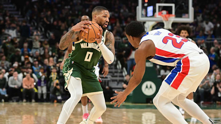Dec 16, 2023; Milwaukee, Wisconsin, USA;  Milwaukee Bucks guard Damian Lillard (0) drives for the basket against Detroit Pistons guard Jaden Ivey (23) in the first quarter at Fiserv Forum. Mandatory Credit: Benny Sieu-Imagn Images