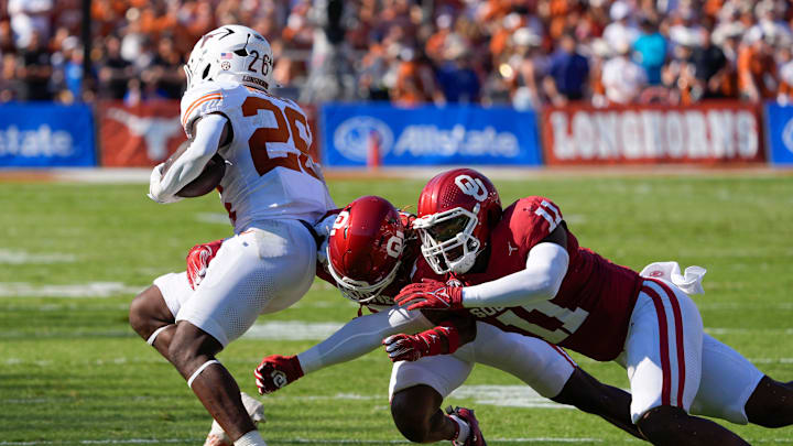 Oklahoma Sooners defensive back Makari Vickers (8) and linebacker Kobie McKinzie (11) chase Texas Longhorns running back Quintrevion Wisner (26). Oklahoma Sooners defensive back Makari Vickers (8) and linebacker Kobie McKinzie (11) chase Texas Longhorns running back Quintrevion Wisner (26).
