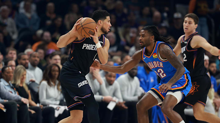 Jan 4, 2026; Phoenix, Arizona, USA; Phoenix Suns guard Devin Booker (1) against Oklahoma City Thunder guard Cason Wallace (22) at Mortgage Matchup Center. Mandatory Credit: Mark J. Rebilas-Imagn Images