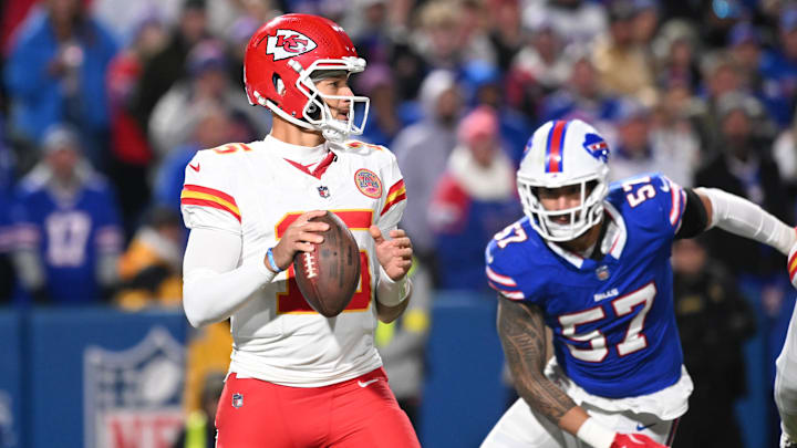 Nov 2, 2025; Orchard Park, New York, USA; Kansas City Chiefs quarterback Patrick Mahomes (15) looks for an open receiver while under pressure from Buffalo Bills defensive end A.J. Epenesa (57) in the second half at Highmark Stadium. Mandatory Credit: Mark Konezny-Imagn Images