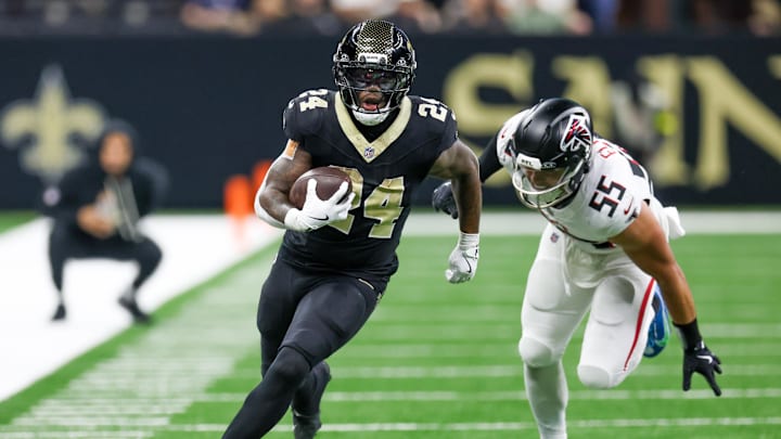 New Orleans Saints running back Devin Neal (24) carries the ball as Atlanta Falcons linebacker Kaden Elliss (55) defends during the second half at Caesars Superdome. 