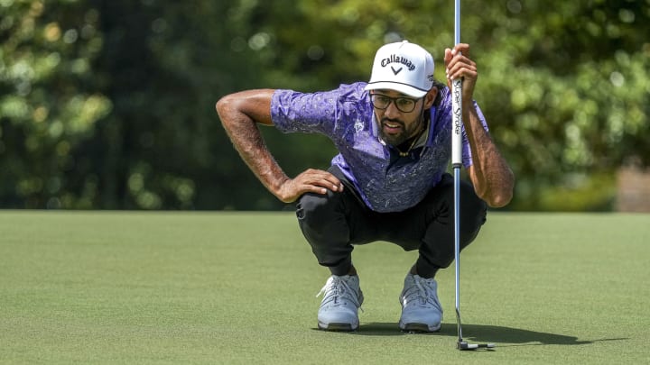 Akshay Bhatia looks over his line on the 14th green during the first round of the Wyndham Championship golf tournament. Akshay Bhatia looks over his line on the 14th green during the first round of the Wyndham Championship golf tournament.