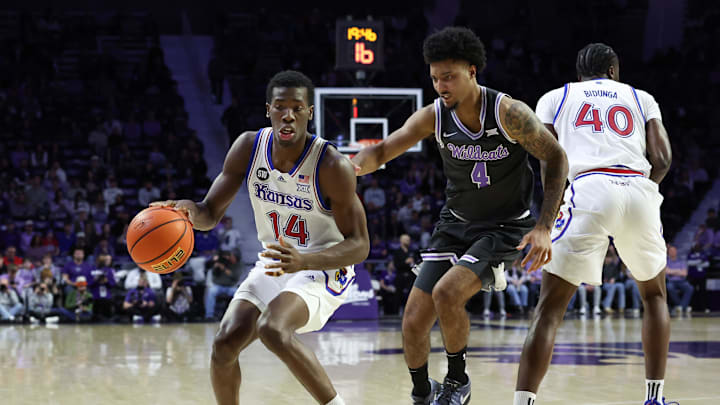 Jan 24, 2026; Manhattan, Kansas, USA; Kansas Jayhawks guard Melvin Council Jr. (14) dribbles against Kansas State Wildcats guard P.J. Haggerty (4) during the second half at Bramlage Coliseum. Mandatory Credit: Scott Sewell-Imagn Images