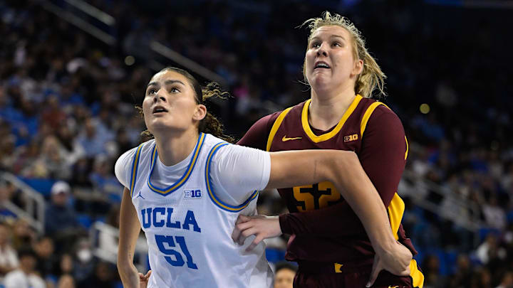 Feb 2, 2025; Los Angeles, California, USA; UCLA Bruins center Lauren Betts (51) and Minnesota Golden Gophers center Sophie Hart (52) jostle for rebounding position during the second quarter at Pauley Pavilion presented by Wescom. Mandatory Credit: Robert Hanashiro-Imagn Images