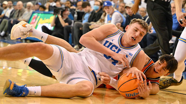 Feb 21, 2026; Los Angeles, California, USA; UCLA forward Tyler Bilodeau (34) and Illinois guard Andrej Stojakovic (2) scramble on the floor for a loose ball during the first half at Pauley Pavilion presented by Wescom Financial. Mandatory Credit: Robert Hanashiro-Imagn Images Feb 21, 2026; Los Angeles, California, USA; UCLA forward Tyler Bilodeau (34) and Illinois guard Andrej Stojakovic (2) scramble on the floor for a loose ball during the first half at Pauley Pavilion presented by Wescom Financial. Mandatory Credit: Robert Hanashiro-Imagn Images