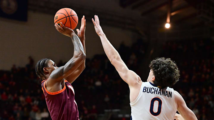 Feb 15, 2025; Blacksburg, Virginia, USA; Virginia Tech Hokies forward Tobi Lawal (1) shoots the ball over Virginia Cavaliers forward Blake Buchanan (0) during the first half at Cassell Coliseum. Mandatory Credit: Brian Bishop-Imagn Images Feb 15, 2025; Blacksburg, Virginia, USA; Virginia Tech Hokies forward Tobi Lawal (1) shoots the ball over Virginia Cavaliers forward Blake Buchanan (0) during the first half at Cassell Coliseum. Mandatory Credit: Brian Bishop-Imagn Images