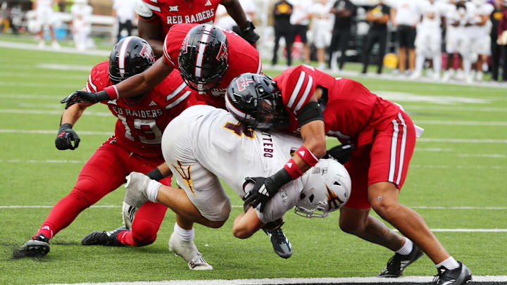 Sep 21, 2024; Lubbock, Texas, USA;  Texas Tech Red Raiders defensive safety CJ Baskerville (9) stops Arizona State Sun Devils running back Cam Skattebo (4) at the goal line in the second half at Jones AT&T Stadium and Cody Campbell Field. Mandatory Credit: Michael C. Johnson-Imagn Images