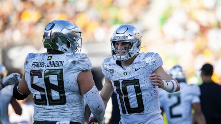 Nov 18, 2023; Tempe, Arizona, USA; Oregon Ducks quarterback Bo Nix (10) celebrates a touchdown with offensive lineman Jackson Powers-Johnson (58) against the Arizona State Sun Devils in the first half at Mountain America Stadium. Mandatory Credit: Mark J. Rebilas-USA TODAY Sports Nov 18, 2023; Tempe, Arizona, USA; Oregon Ducks quarterback Bo Nix (10) celebrates a touchdown with offensive lineman Jackson Powers-Johnson (58) against the Arizona State Sun Devils in the first half at Mountain America Stadium. Mandatory Credit: Mark J. Rebilas-USA TODAY Sports