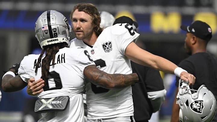 Oct 20, 2024; Inglewood, California, USA; Las Vegas Raiders running back Ameer Abdullah (8) and punter AJ Cole (6) hug during pregame warm-ups before an NFL game against there Los Angeles Rams at SoFi Stadium. Mandatory Credit: Robert Hanashiro-Imagn Images