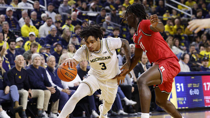 Dec 6, 2025; Ann Arbor, Michigan, USA; Michigan Wolverines guard Elliot Cadeau (3) dribbles defended by Rutgers Scarlet Knights forward Chris Nwuli (11) in the first half at Crisler Center. Mandatory Credit: Rick Osentoski-Imagn Images Dec 6, 2025; Ann Arbor, Michigan, USA; Michigan Wolverines guard Elliot Cadeau (3) dribbles defended by Rutgers Scarlet Knights forward Chris Nwuli (11) in the first half at Crisler Center. Mandatory Credit: Rick Osentoski-Imagn Images