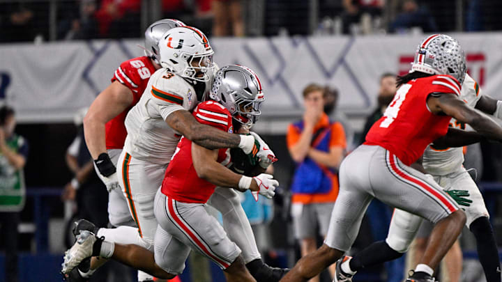 Dec 31, 2025; Arlington, TX, USA; Miami Hurricanes defensive lineman Akheem Mesidor (3) tackles Ohio State Buckeyes running back CJ Donaldson (12) during the 2025 Cotton Bowl and quarterfinal game of the College Football Playoff at AT&T Stadium. Mandatory Credit: Jerome Miron-Imagn Images