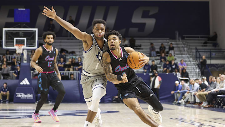 Jan 24, 2024; Houston, Texas, USA; Florida Atlantic Owls guard Nick Boyd (2) drives with the ball as Rice Owls guard Noah Shelby (1) defends during the first half at Tudor Fieldhouse. Mandatory Credit: Troy Taormina-Imagn Images