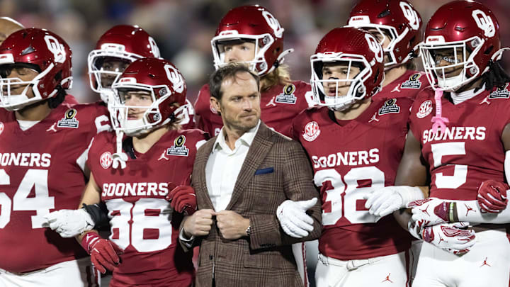 Oklahoma general manager Jim Nagy locks arms with the team ahead of OU's CFP matchup with Alabama.