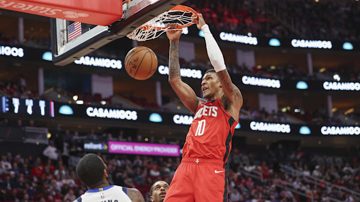 Jan 1, 2025; Houston, Texas, USA; Houston Rockets forward Jabari Smith Jr. (10) dunks the ball as Dallas Mavericks guard Kyrie Irving (11) defends during the first quarter at Toyota Center. Mandatory Credit: Troy Taormina-Imagn Images Jan 1, 2025; Houston, Texas, USA; Houston Rockets forward Jabari Smith Jr. (10) dunks the ball as Dallas Mavericks guard Kyrie Irving (11) defends during the first quarter at Toyota Center. Mandatory Credit: Troy Taormina-Imagn Images